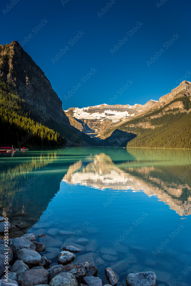 Amazing lake surrounded by mountains and glaciers in a blue sky day in Banff National Park in Canada Amazing lake surrounded by mountains and glaciers in a blue sky day in Banff National Park in Canada