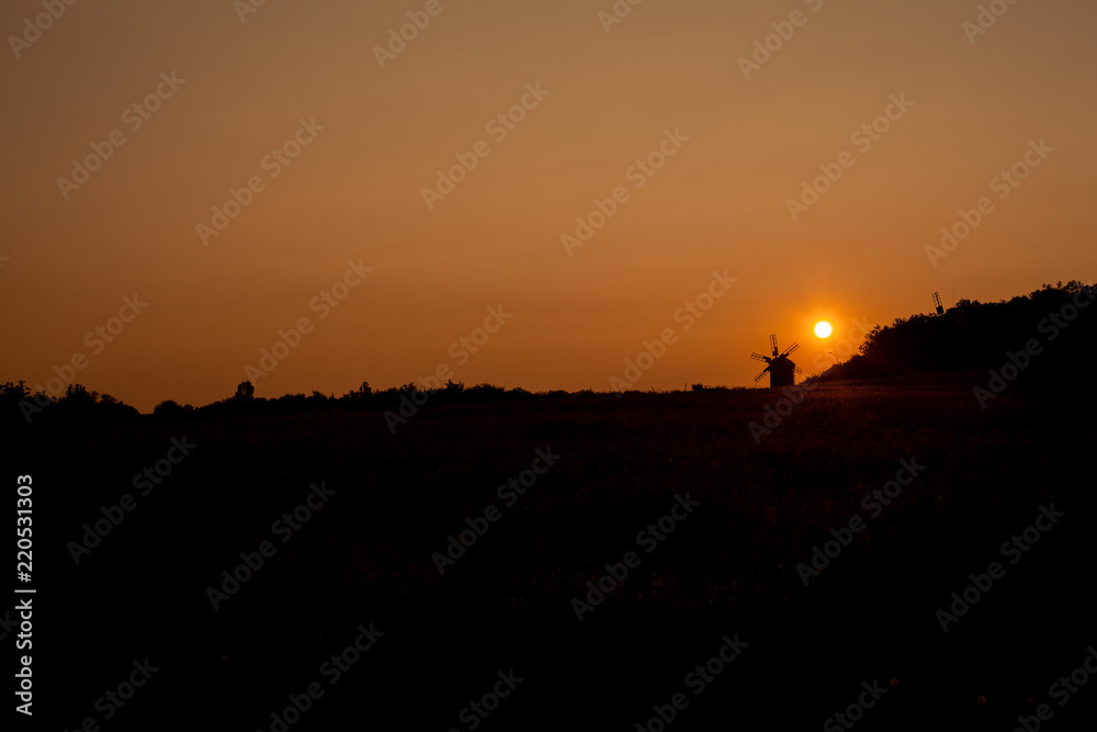 Beautiful field on a red sunset background. Control Lighting