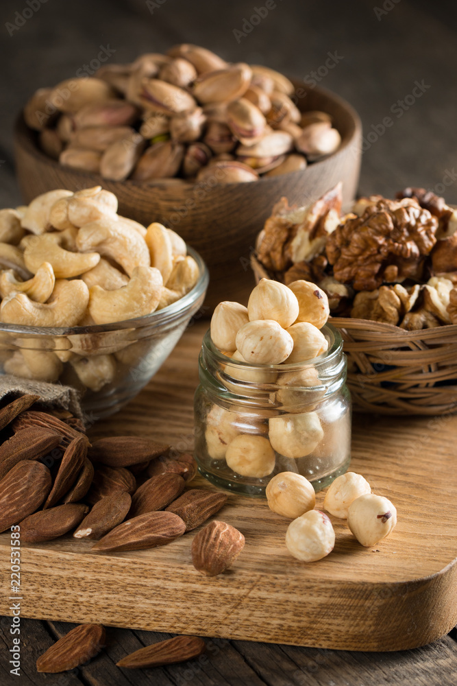 mix of nuts on a wooden table mix of nuts on a wooden table