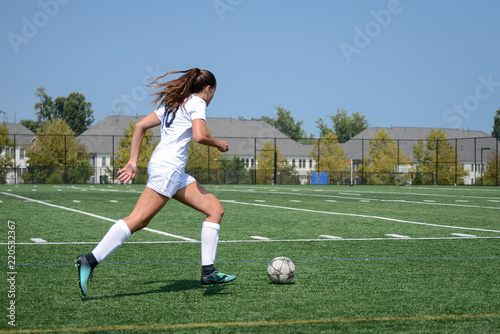 Girl sprinting towards the goal by herself