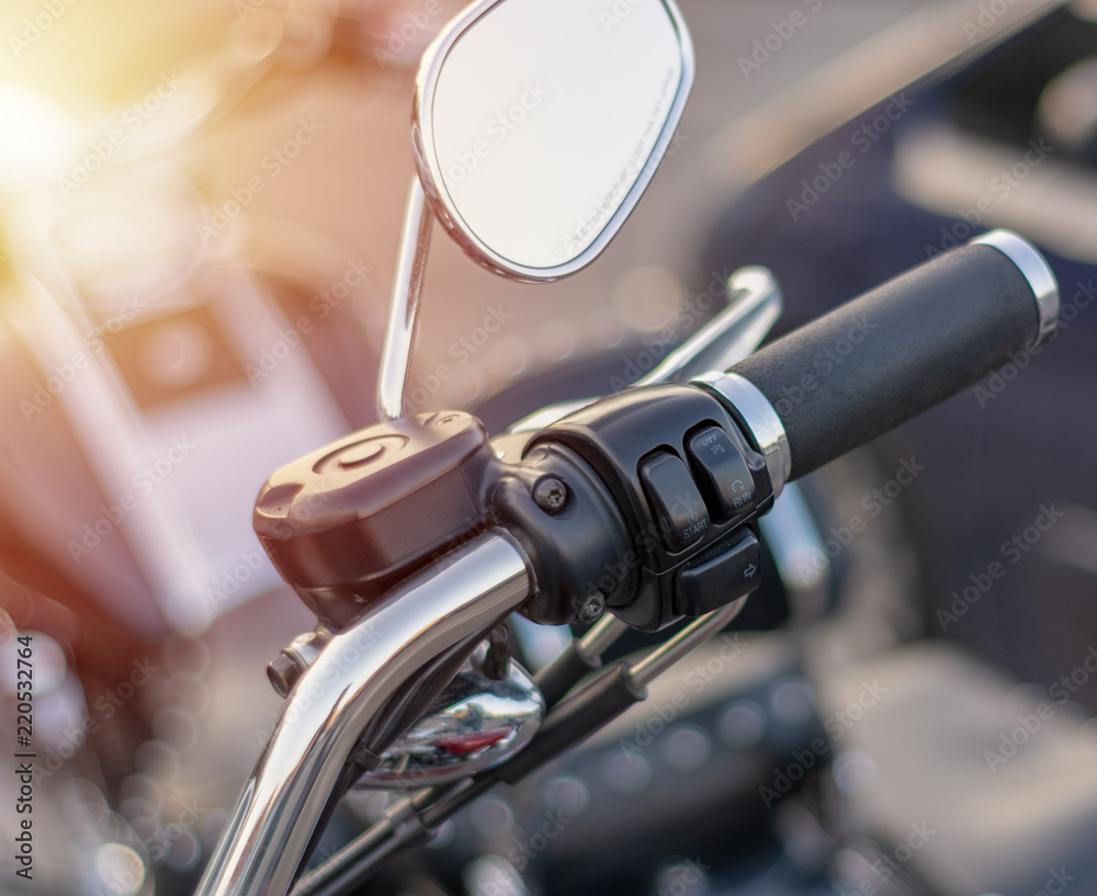 close-up of handle mirror on the handlebars of a motorcycle close-up of handle mirror on the handlebars of a motorcycle