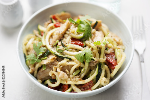 Vegetarian stir fry with chilli & coriander soya chunks with spiralled courgette spaghetti and semi dried tomatoes  photo