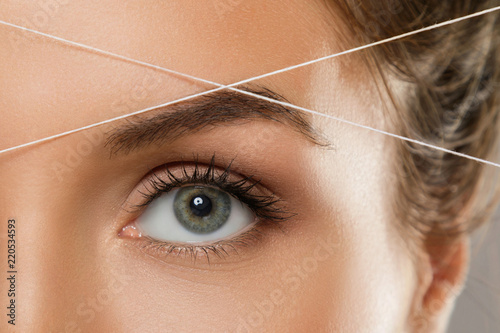 Eyebrow threading - epilation procedure for brow shape correction