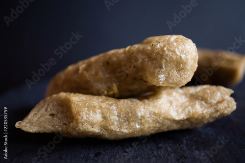 Malaysian traditional foods, keropok or fried fish cake crackers in black background photo