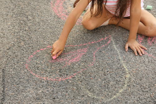Little girl drawing with ch...
