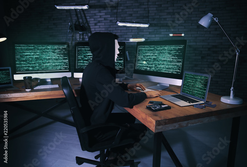 Masked hacker using compute...