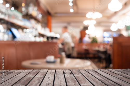 Perspective wood and blurred cafe with bokeh light background.