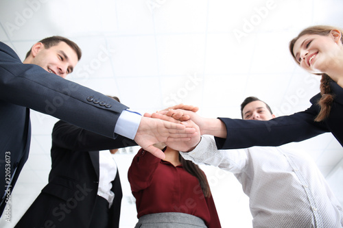 People putting hands togeth...