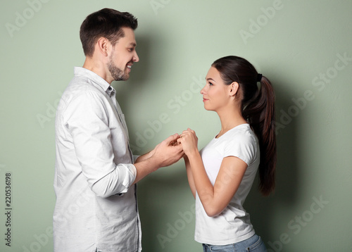 Young couple holding hands ...