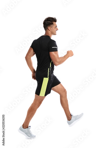 Sporty young runner walking on white background
