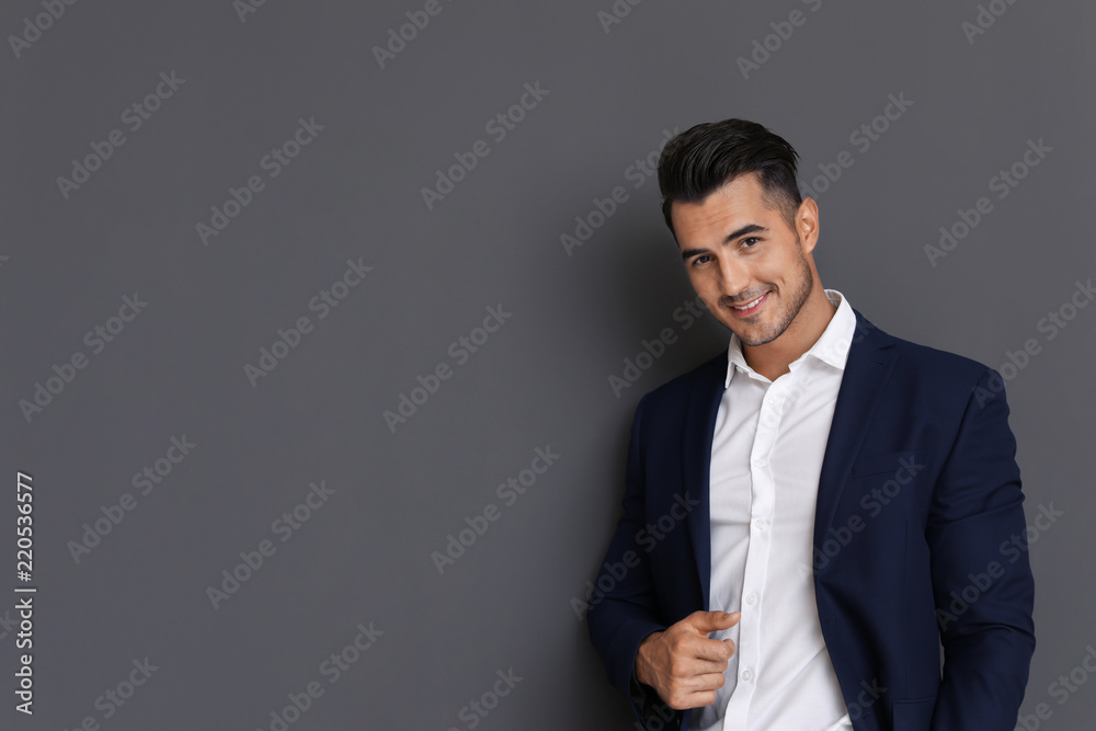 Portrait of handsome young man and space for text on grey background Portrait of handsome young man and space for text on grey background
