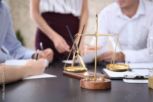 Scales of justice on table ...