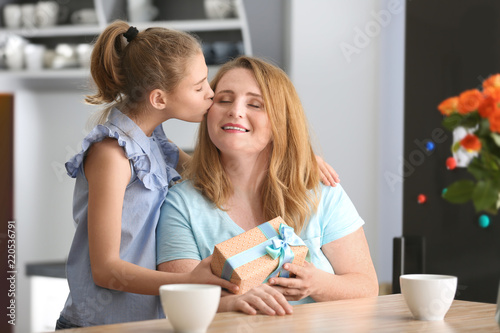 Cute little girl giving her...