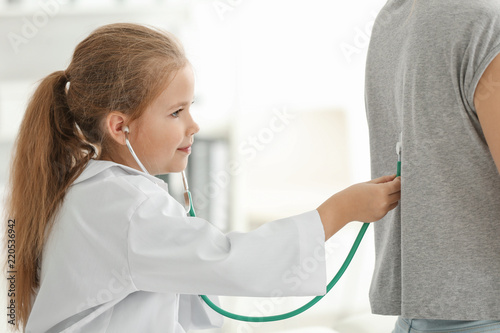 Cute little girl in doctor ...