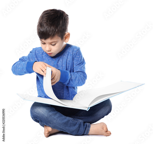 Cute little boy reading boo...