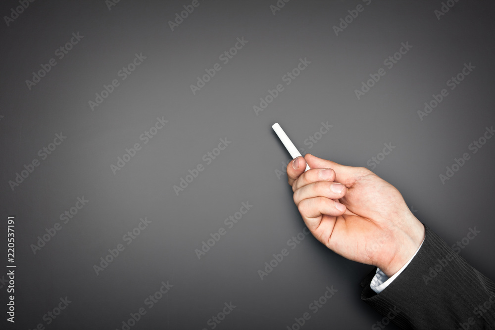 Naklejka premium Empty blackboard with businessman hand holding chalk