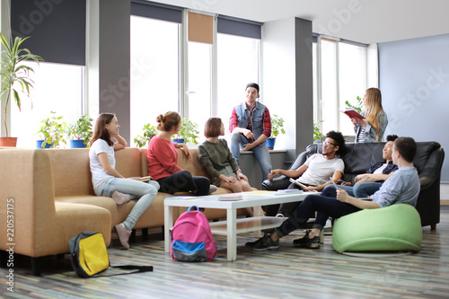 Students resting together in campus building photo