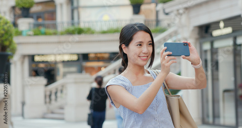 Woman taking photo on cellphone at outdoor
