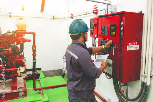 Engineer checking industrial generator fire control system