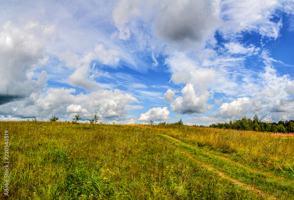 Landscape with clouds in the summer sky. The last days of August.