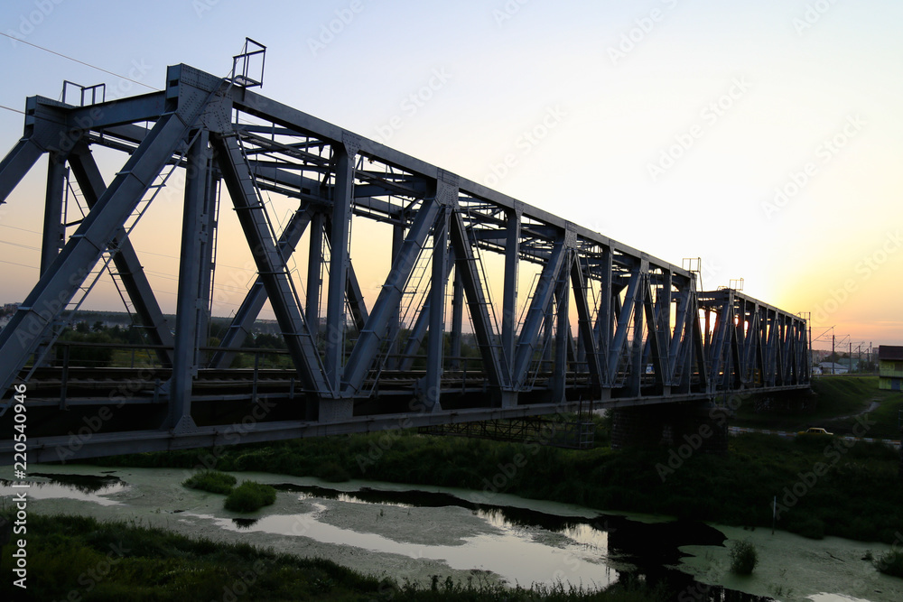 Sunset on the railway bridge. Evening Sunset on the railway bridge. Evening