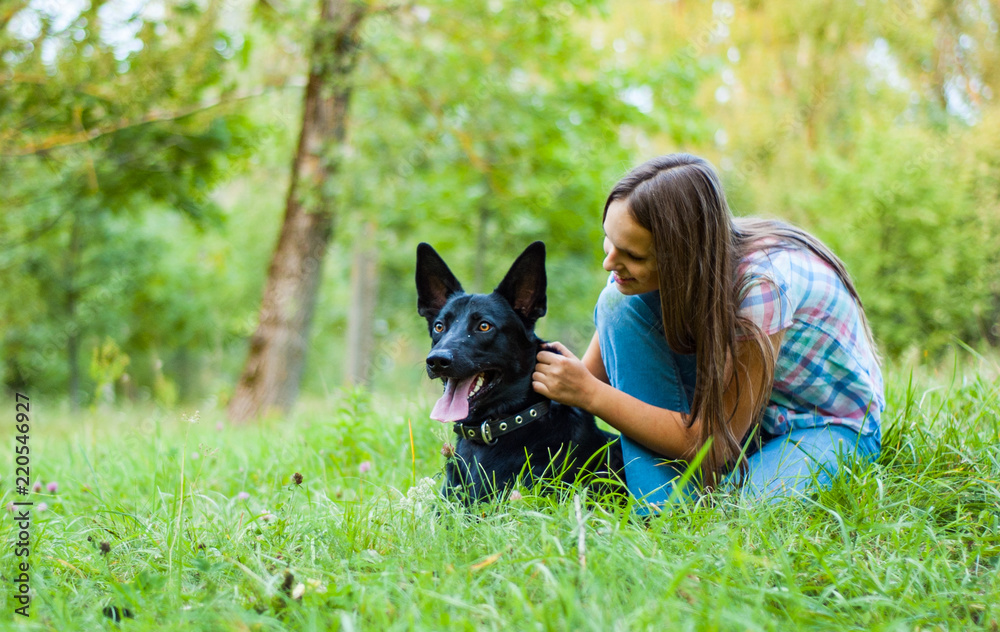 Portrait of young teenage girl with a shepherd dog in the park outdoor Portrait of young teenage girl with a shepherd dog in the park outdoor