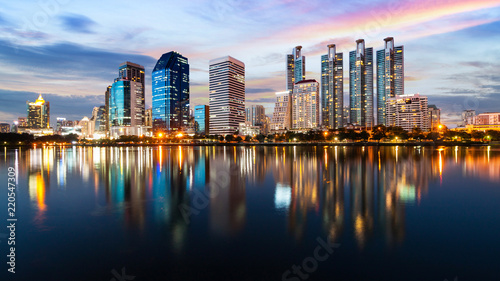 Bangkok Cityscape at Benjakiti public park at dusk, reflection of skyscrappers on water