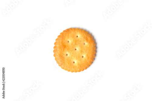Top view of round salted cracker cookie isolated on white background.
