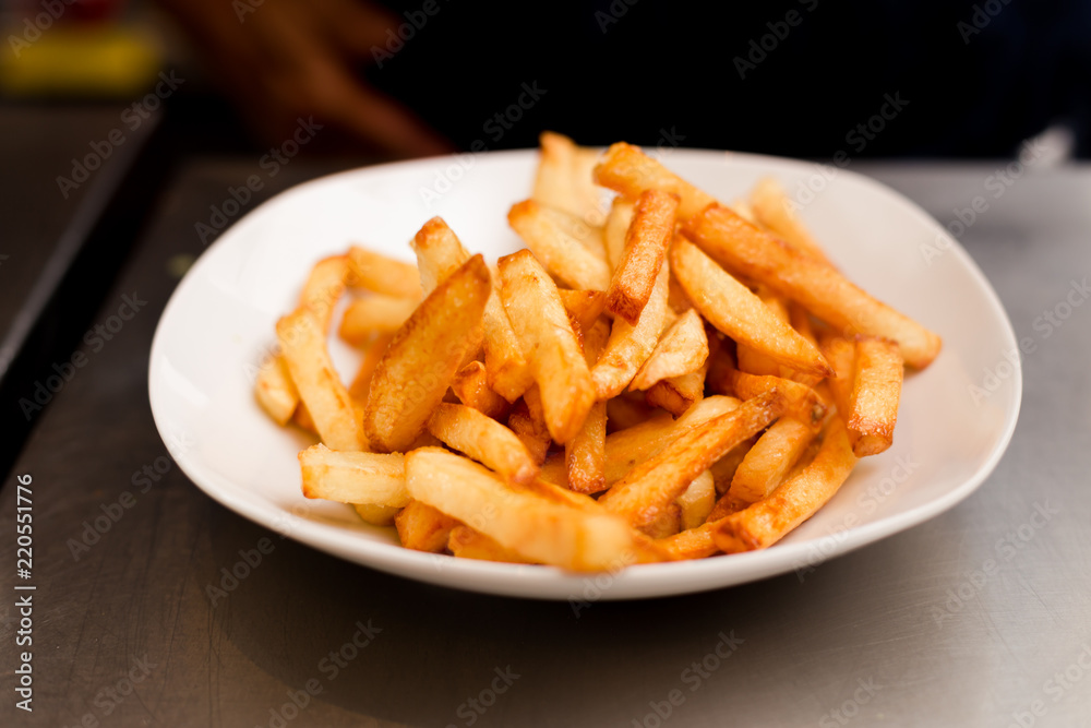 French fries on a plate, isolated on white background. French fries on a plate, isolated on white background.
