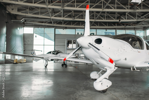 Small private turbo-propeller airplane in hangar