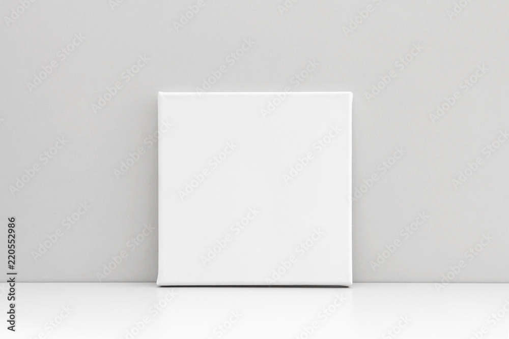 White square canvas on neutral gray background. Mock up poster, canvas template. White square canvas on neutral gray background. Mock up poster, canvas template.