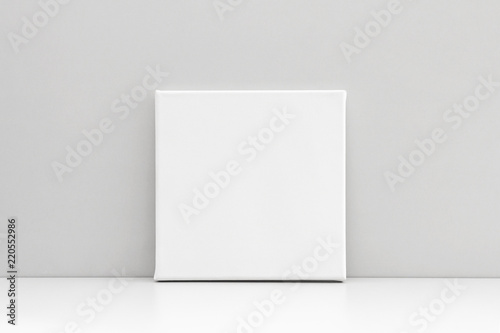 White square canvas on neutral gray background. Mock up poster, canvas template. photo