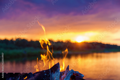 bonfire by the river at sunset