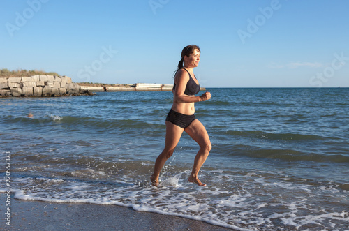 athlete running along the seashore