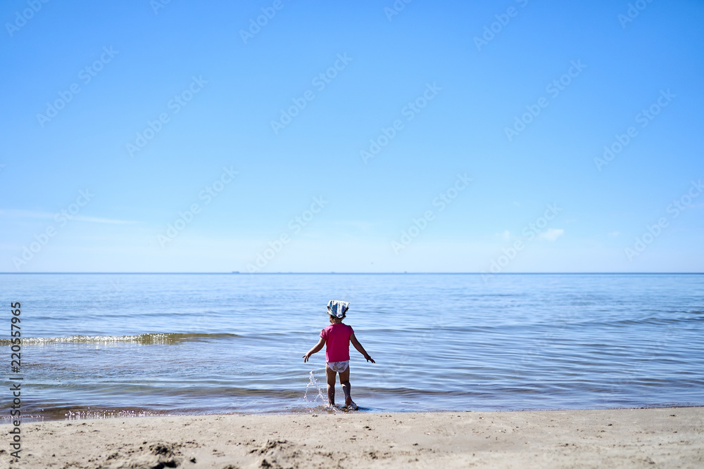 girl child is playing in the sandy beach in summer girl child is playing in the sandy beach in summer