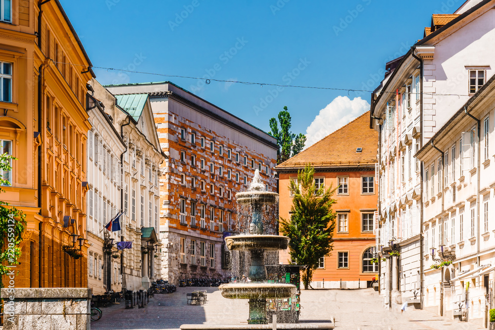 View on building and fountain next to fountain novi trg square in Ljubljana