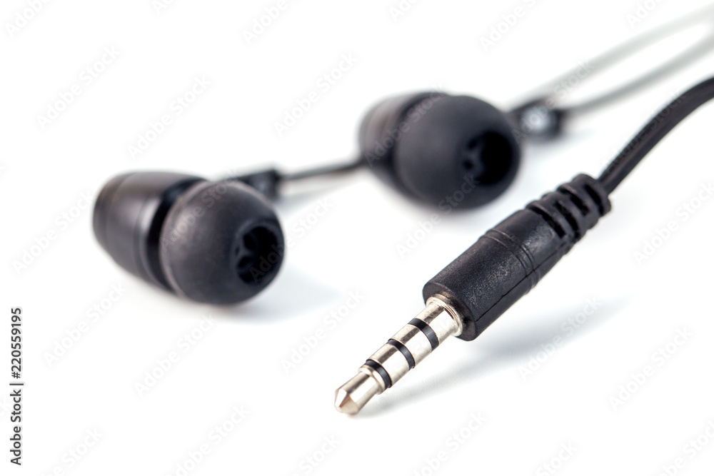 Black headphones on a white background, close up Black headphones on a white background, close up
