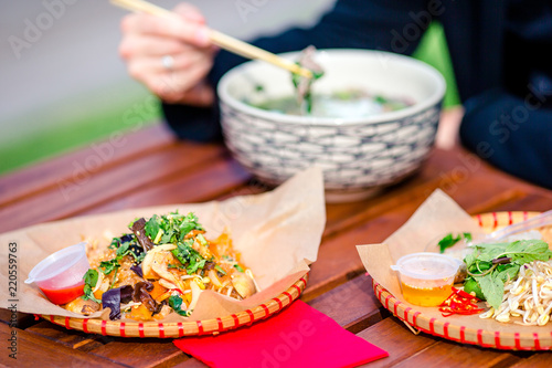 Asian rice noodles with vegetables and sause close-up on the table photo