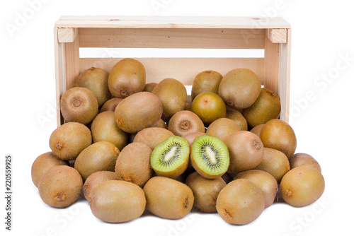 Wooden box with ripe and fresh kiwi fruits in front of it isolated on white background