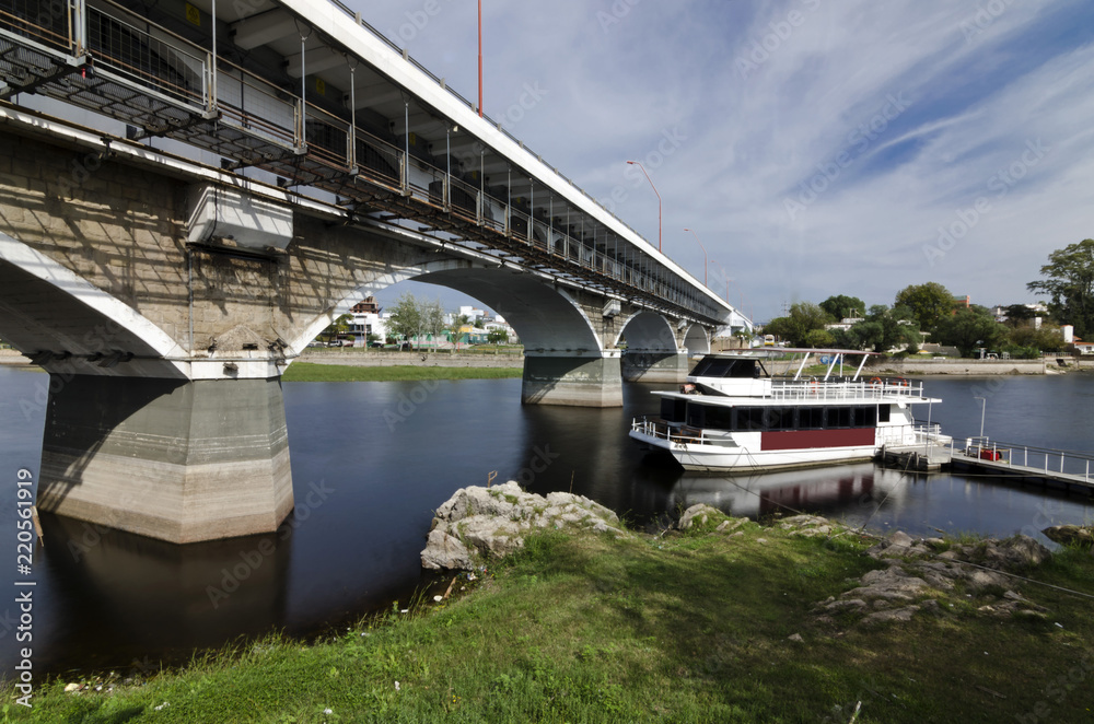 bridge over the river with anchored boat