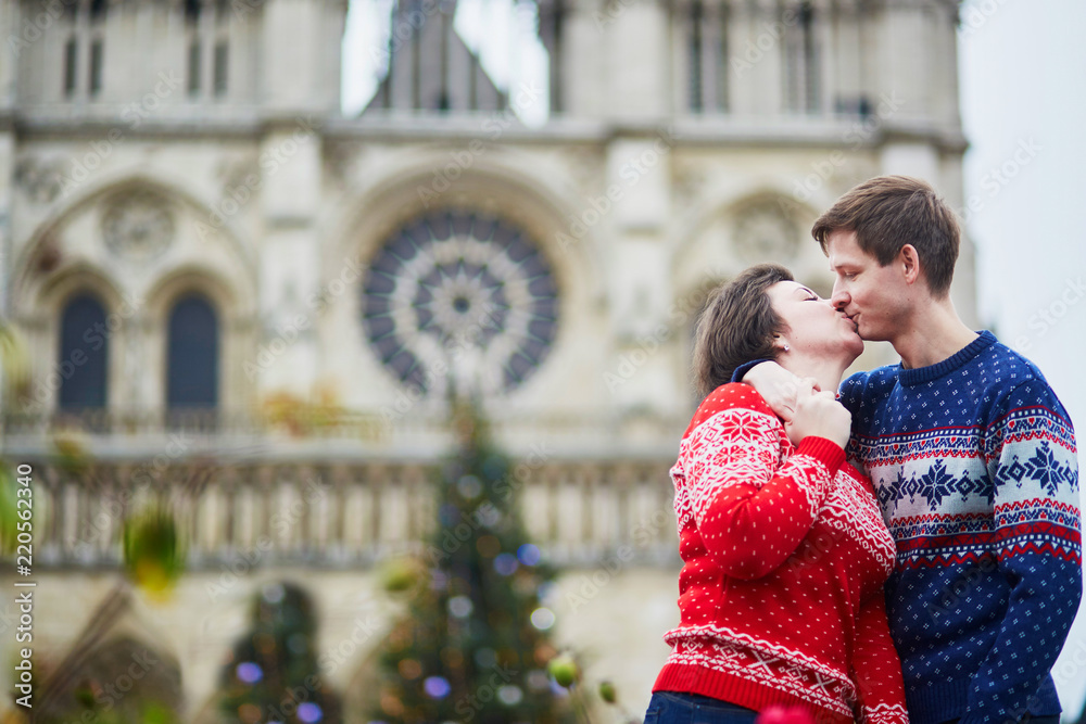 Couple on a street of Paris decorated for Christmas Couple on a street of Paris decorated for Christmas