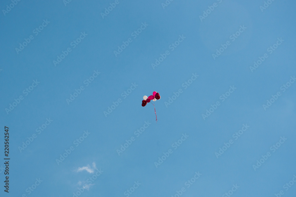 Background colorful balloons flying in the blue sky with clouds Background colorful balloons flying in the blue sky with clouds