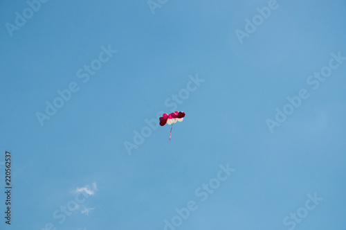 Background colorful balloons flying in the blue sky with clouds