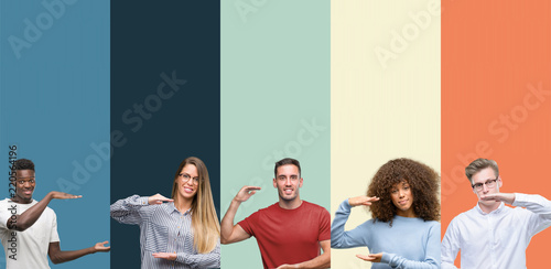 Group of people over vintage colors background gesturing with hands showing big and large size sign, measure symbol. Smiling looking at the camera. Measuring concept.