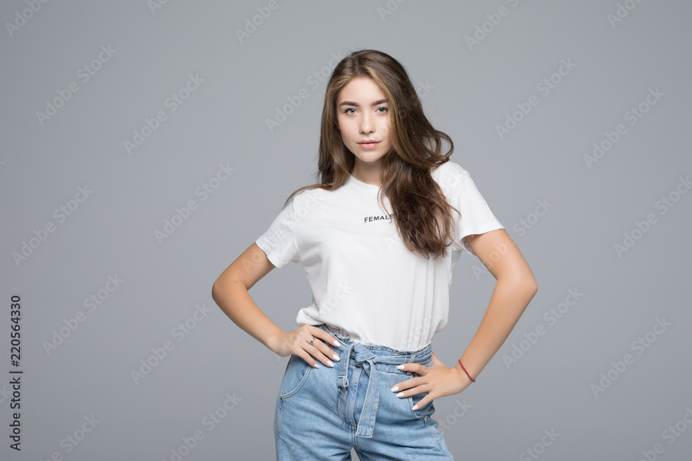 portrait of young pretty woman smiling in t-shirt on gray background portrait of young pretty woman smiling in t-shirt on gray background