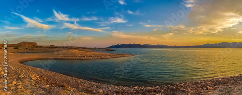 Obraz na plátně Beautiful panoramic landscape of the Lake Mead National Recreation Area from its muddy shore at sunset in summer, Nevada
