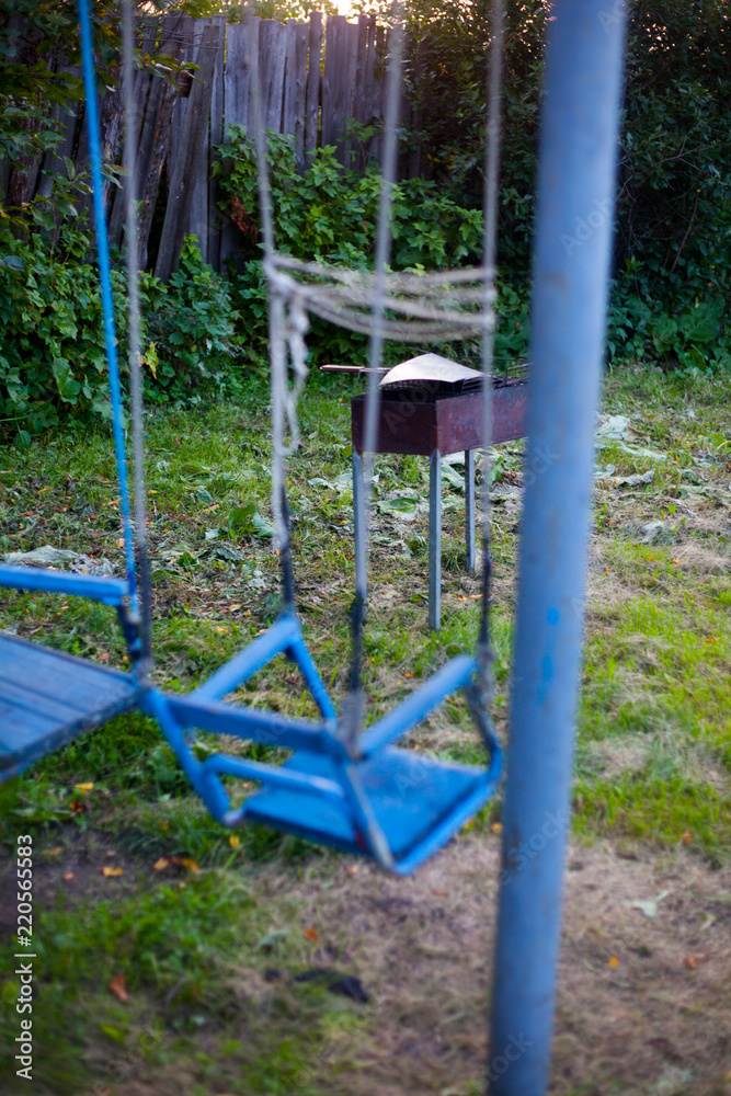 blue wooden swing in the garden