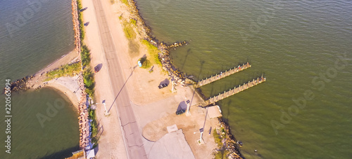 Panorama aerial view famous Texas City Dike with wooden piers, a levee that project nearly 5miles south-east into mouth of Galveston Bay. Designed to reduce impact of sediment accumulation along bay photo