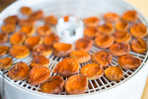 ripe segments of ripe apricots are dried in an electric dryer to preserve vitamins