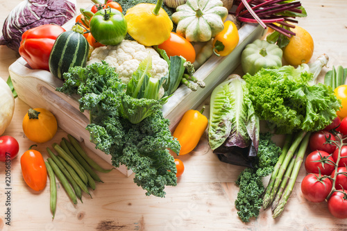 Assortment of fresh colorful organic vegetables in white tray on wooden pine table  food background  selective focus